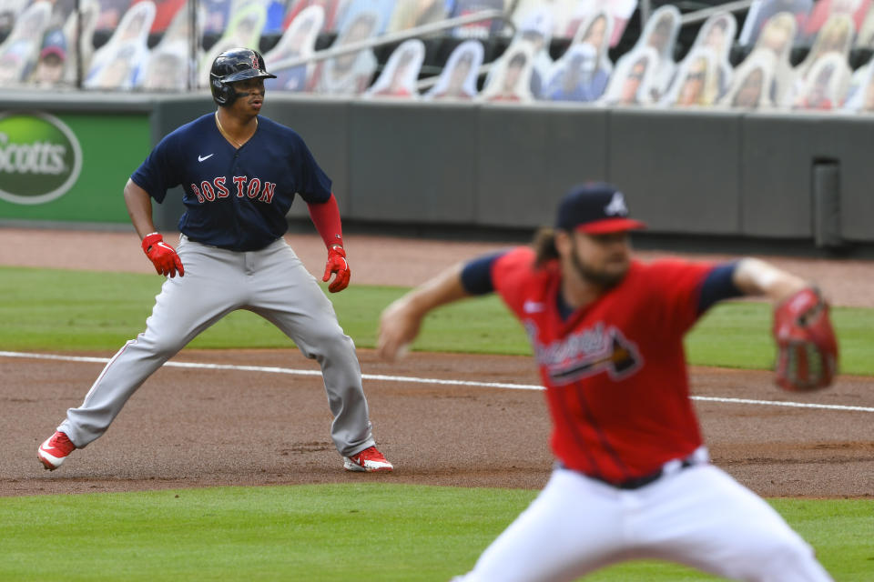 Boston Red Sox' Rafael Devers plays off first base as Atlanta Braves' Bryse Wilson pitches, after Devers hit a one-run RBI single to left field during the first inning of a baseball game Sunday, Sept. 27, 2020, in Atlanta. (AP Photo/John Amis)