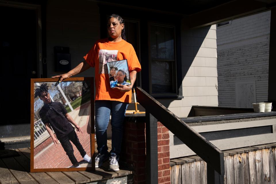 Shawna Brady holds photos Wednesday of her 15-year-old son, TréVon Dickson, who was fatally shot in 2021 outside their East Side apartment.