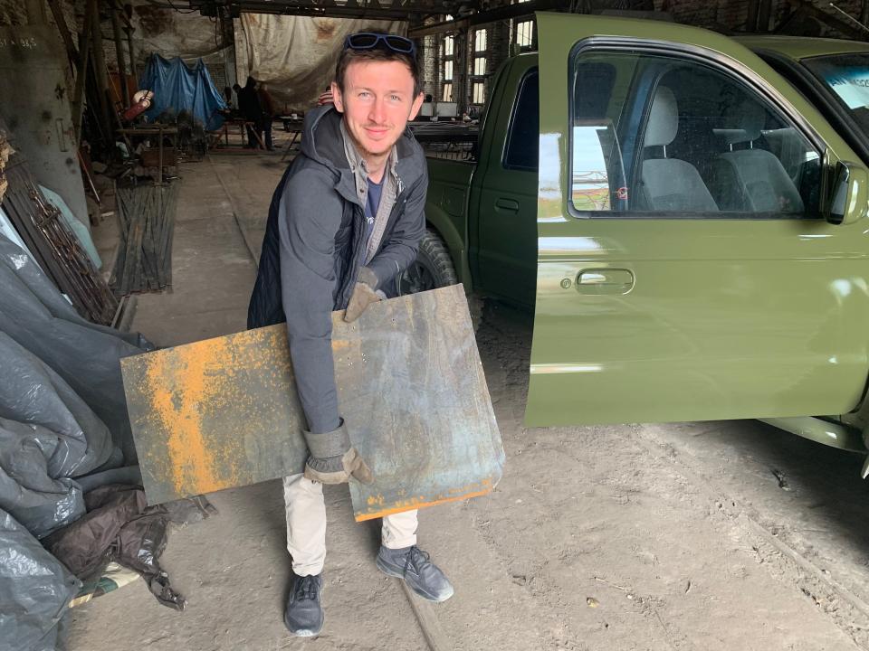 Ivan Oleksii with a the metal armour used to protect the vehicle from explosions