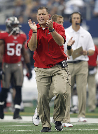 Tampa Bay Buccaneers head coach Greg Schiano claps during the first half of their NFL football game against the Dallas Cowboys in Arlington, Texas September 23, 2012. REUTERS/Mike Stone