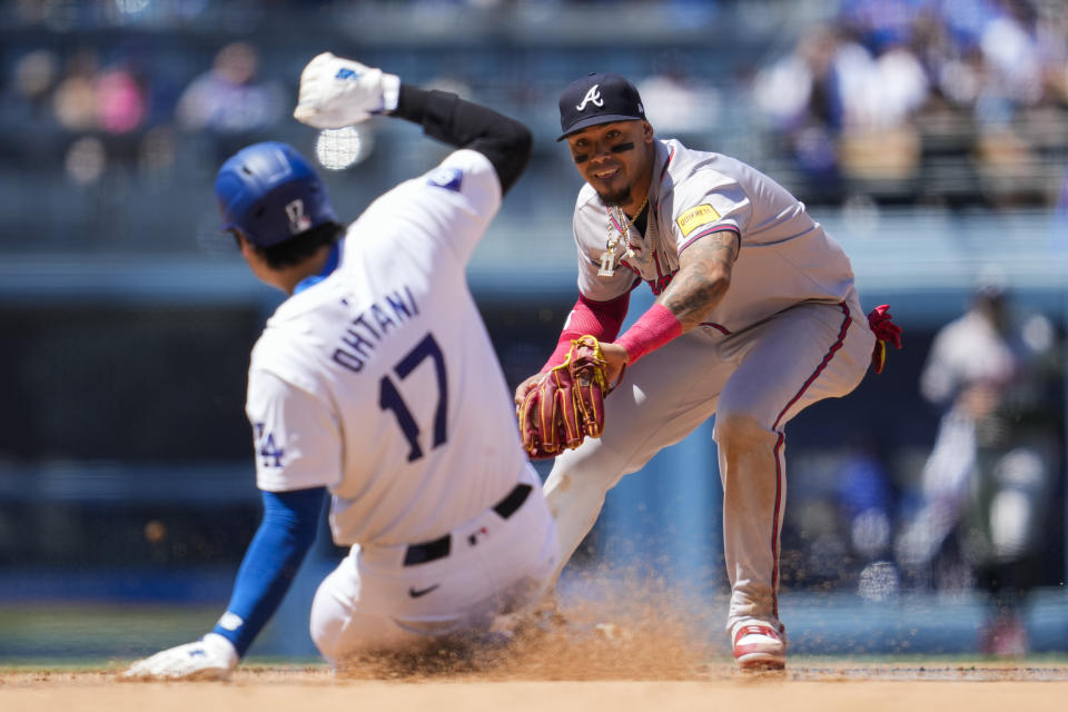 Los Angeles Dodgers designated hitter Shohei Ohtani is out at second ahead of a throw to Atlanta Braves shortstop Orlando Arcia, right, during the sixth inning of a baseball game against the Atlanta Braves in Los Angeles, Sunday, May 5, 2024. Freddie Freeman grounded in to a force out. (AP Photo/Ashley Landis)