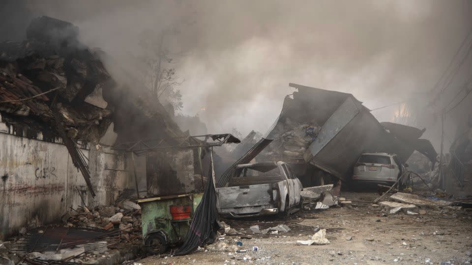 Destroyed vehicles and debris are scattered on the ground after the incident in San Cristobal. - Jolivel Brito/AP