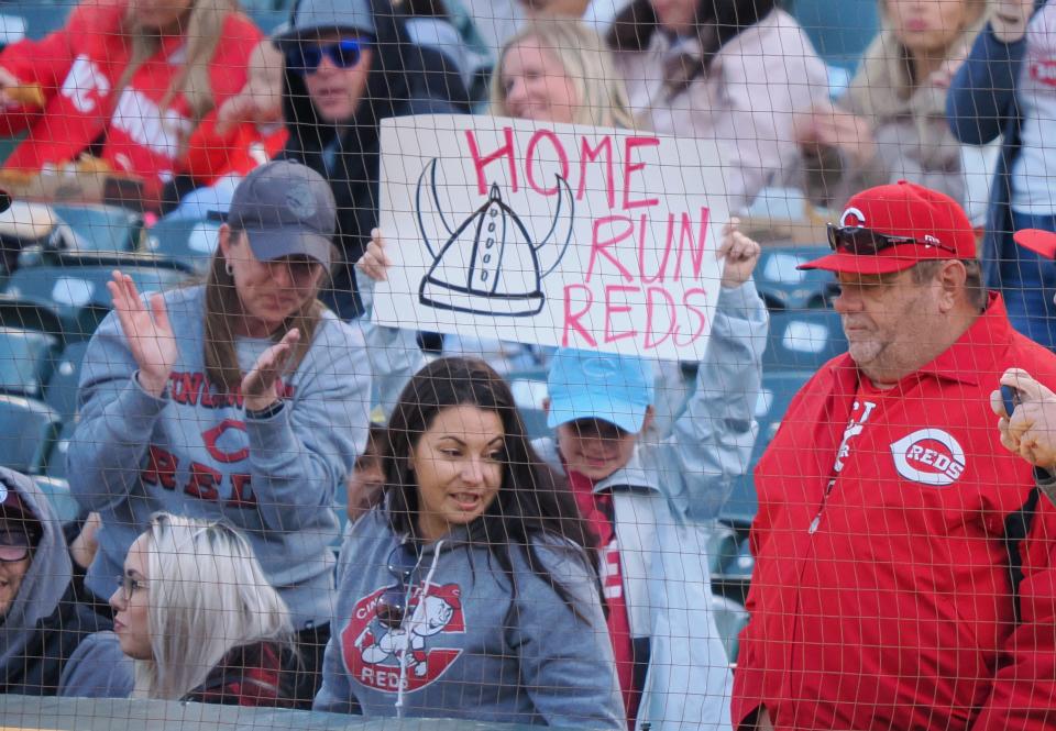 Apr 28, 2023; Oakland, California, USA; A Cincinnati Reds fan holds a sign reading “home run reds” after a home run by Cincinnati Reds outfielder Jake Fraley (not pictured) during the third inning against the Oakland Athletics at Oakland Coliseum. Mandatory Credit: Kelley L Cox-USA TODAY Sports