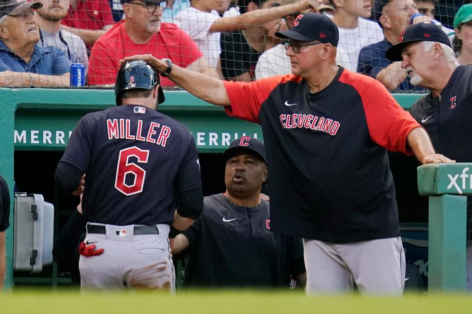 Cleveland Guardians manager Terry Francona gives Owen Miller (6) a tap on the helmet after Miller scored on a groundout by Austin Hedges during the second inning of the team's baseball game against the Boston Red Sox at Fenway Park, Wednesday, July 27, 2022, in Boston. (AP Photo/Charles Krupa)