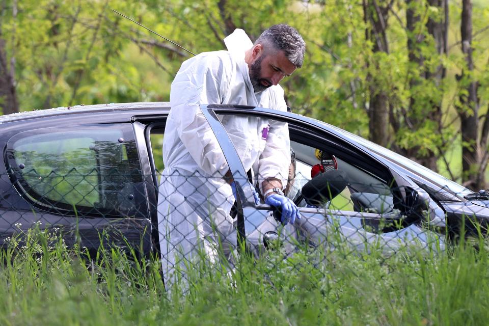 Forensic police operates on a car in the the village of Dubona, some 50 kilometers (30 miles) south of Belgrade, Serbia, Friday, May 5, 2023.