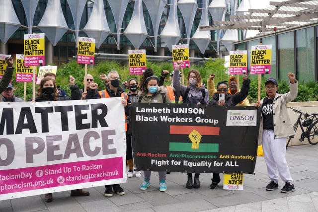 People take part in a BLM protest to commemorate the death of George Floyd