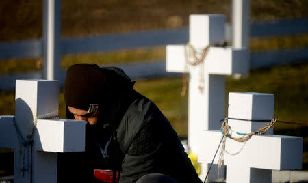 A relative of an Argentine soldier who died during the Falklands War reacts during his visit to Darwin cemetery, in the Falkland Islands, March 26, 2018. Argentine Presidency/Handout via REUTERS ATTENTION EDITORS - THIS IMAGE WAS PROVIDED BY A THIRD PARTY.