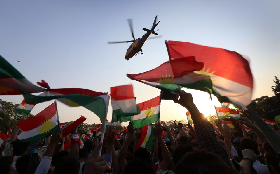 <p>A helicopter flies over an Iraqi Kurd gathering where people were being urged to vote in the upcoming independence referendum in Arbil, the capital of the autonomous Kurdish region of northern Iraq, Sept. 15, 2017. (Photo: Safin Hamed/AFP/Getty Images) </p>