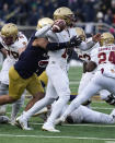 Boston College quarterback Emmett Morehead looks to throw while pressured by Notre Dame's Howard Cross III during the first half of an NCAA college football game, Saturday, Nov. 19, 2022, in South Bend, Ind. (AP Photo/Darron Cummings)