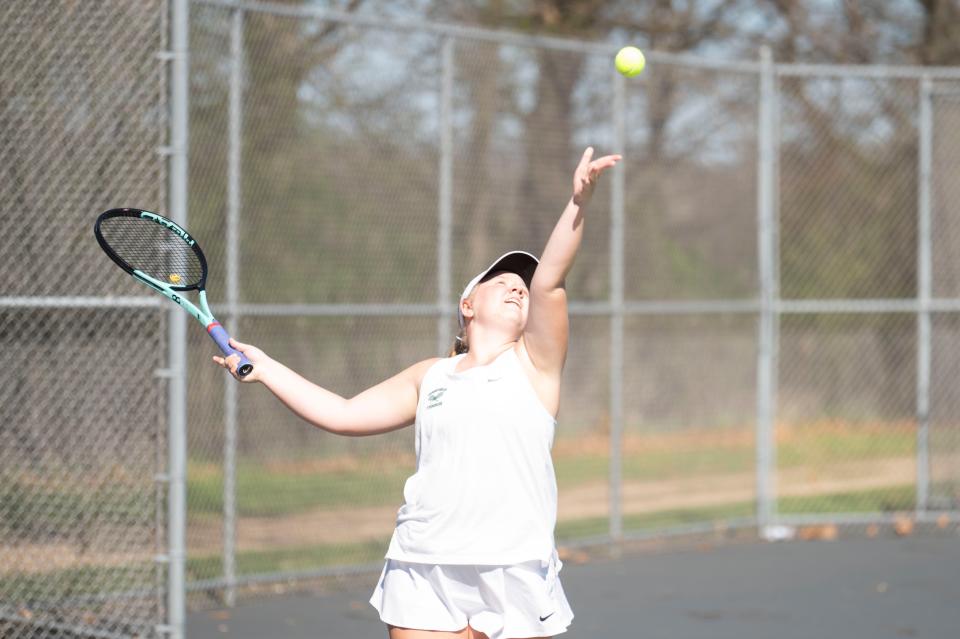 Pennfield senior Vivian Burns serves during a match against Hastings at Pennfield High School on Monday, April 15, 2024.