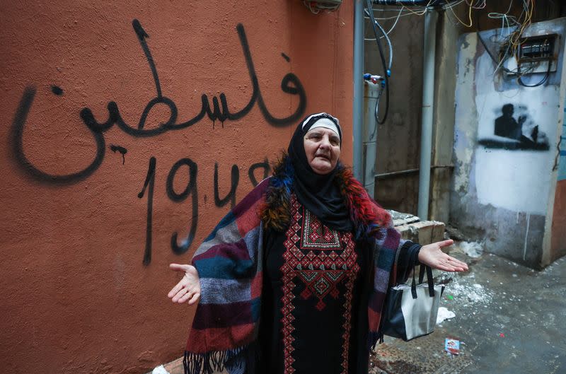 A Palestinian woman, Umm Issam Moussa, gestures inside Burj al-Barajneh refugee camp in Beirut