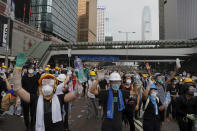 FILE - Protesters gesture to riot police during a massive demonstration outside the Legislative Council in Hong Kong on June 12, 2019. When the British handed its colony Hong Kong to Beijing in 1997, it was promised 50 years of self-government and freedoms of assembly, speech and press that are not allowed Chinese on the Communist-ruled mainland. As the city of 7.4 million people marks 25 years under Beijing's rule on Friday, those promises are wearing thin. Hong Kong's honeymoon period, when it carried on much as it always had, has passed, and its future remains uncertain, determined by forces beyond its control. (AP Photo/Kin Cheung, File)