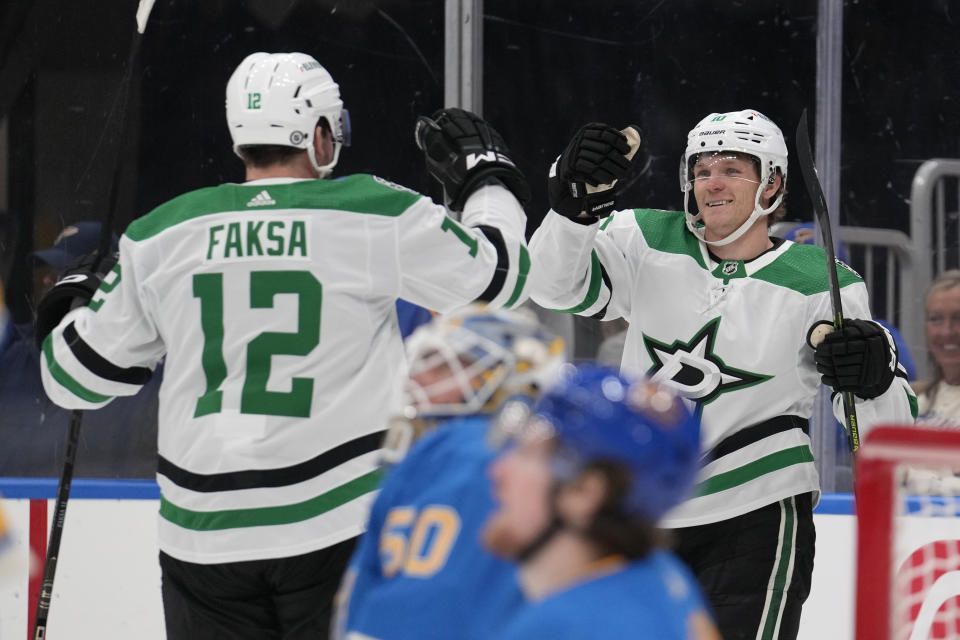 Dallas Stars' Ty Dellandrea, right, is congratulated by Radek Faksa (12) after scoring during the first period of an NHL hockey game against the St. Louis Blues Saturday, Dec. 16, 2023, in St. Louis. (AP Photo/Jeff Roberson)