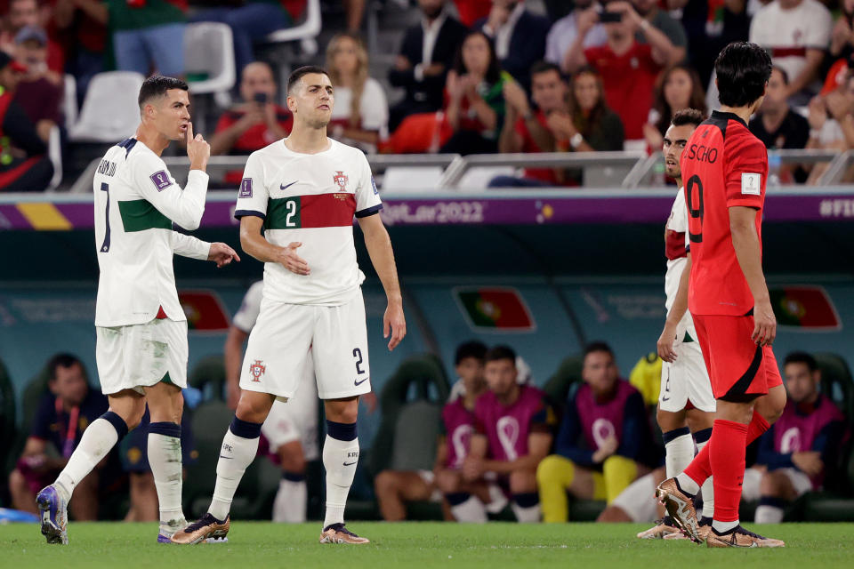 AL RAYYAN, QATAR - DECEMBER 2:  (L-R) Cristiano Ronaldo of Portugal, Diogo Dalot of Portugal, Guesung Cho of Korea Republic  during the  World Cup match between Korea Republic  v Portugal at the Education City Stadium on December 2, 2022 in Al Rayyan Qatar (Photo by David S. Bustamante/Soccrates/Getty Images)