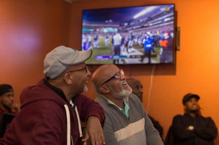 Jamal Said (L) of St. Louis Park and Abdul Hersi of Minneapolis, watch the Minnesota Vikings in the NFC Championship football game at the Capitol Cafe, a popular Somali coffee shop, ahead of the NFL's Super Bowl in Minneapolis, Minnesota, U.S. January 21, 2018. REUTERS/Craig Lassig/Files