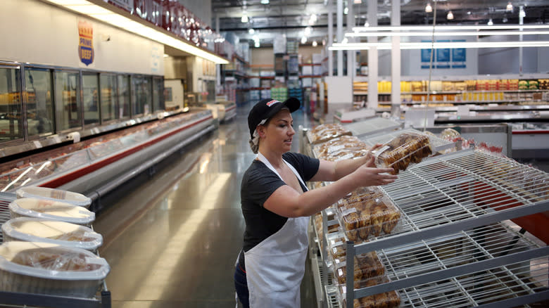 Costco bakery associate stocking shelves