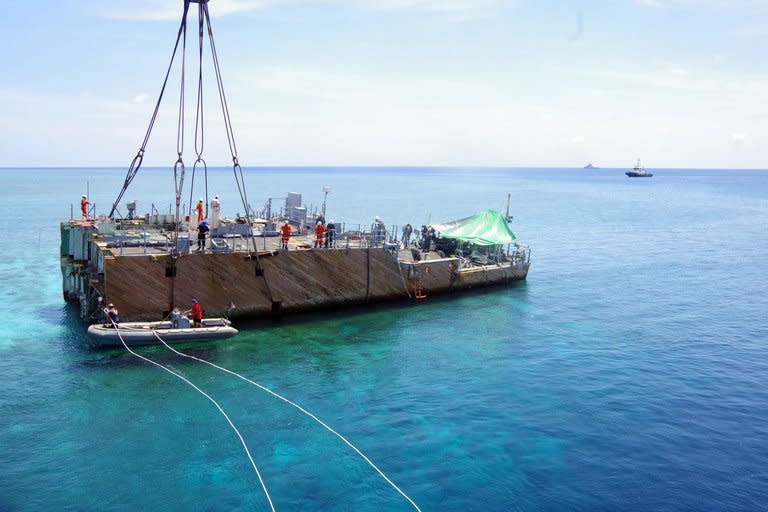 This undated handout photo released on March 30, 2013 by Philippine Coast Guard (PCG) shows the stern of the USS Guardian before being lifted by a boat crane during its salvage operation at Tubbataha reef, in Palawan island, western Philippines. The commanding officer and three crew have been relieved of their duties, the US Navy said Thursday