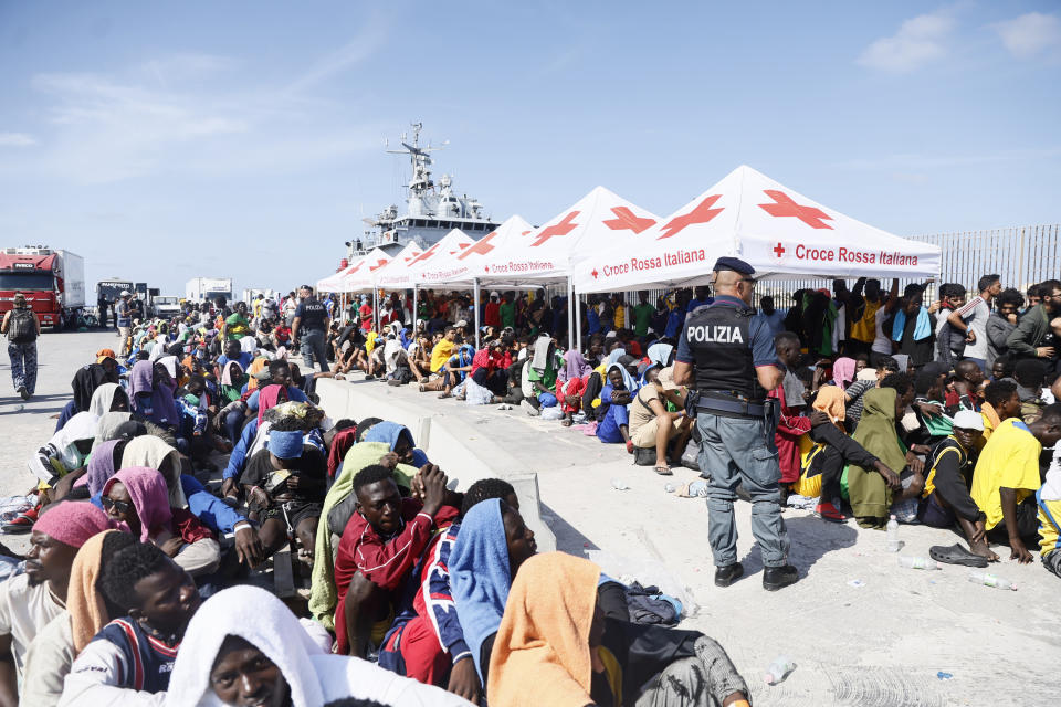 Migrants wait to be transferred from the Lampedusa Island to the mainland, Friday, Sept. 15, 2023. Thousands of migrants and refugees have landed on the Italian island of Lampedusa this week after crossing the Mediterranean Sea on small unseaworthy boats from Tunisia, overwhelming local authorities and aid organizations .(Cecilia Fabiano/LaPresse via AP)