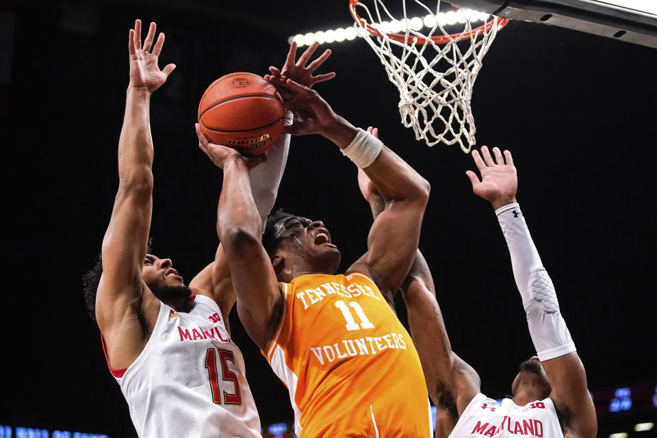 Maryland forward Patrick Emilien (15) and guard Hakim Hart (13) attempt to block Tennessee forward Tobe Awaka (11) as he goes up to shoot during the first half of an NCAA college basketball game in the Basketball Hall of Fame Invitational, Sunday, Dec. 11, 2022, in New York. (AP Photo/Julia Nikhinson)
