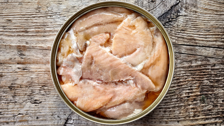 canned salmon on wooden background