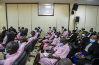 Other defendants and lawyers sit in the courtroom in the case of Paul Rusesabagina, who boycotted the announcement of the verdict, at a court in Kigali, Rwanda Monday, Sept. 20, 2021. The man who inspired the film "Hotel Rwanda" has been convicted of terrorism offenses and sentenced to 25 years in prison in a trial that human rights watchdogs and other critics of Rwanda's repressive government have described as an act of retaliation. (AP Photo/Muhizi Olivier)