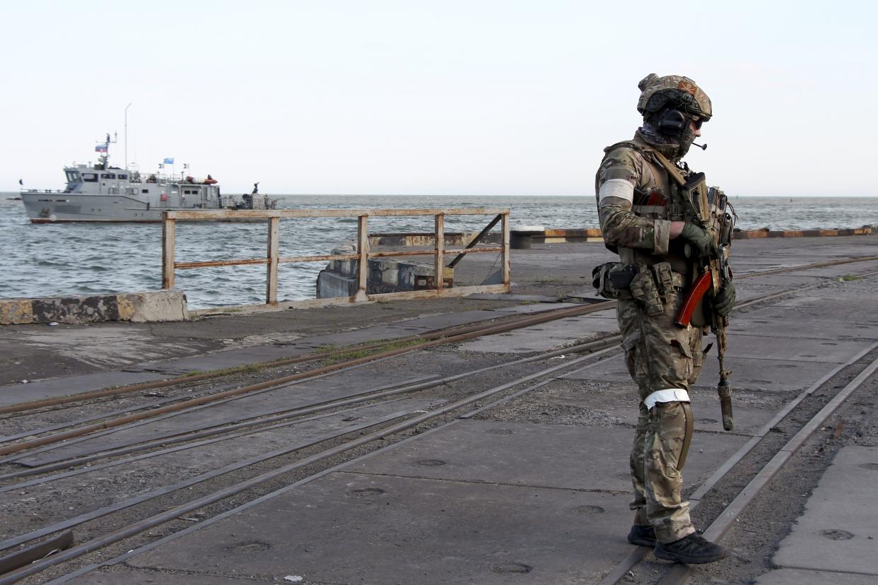 A Russian serviceman stands guarding an area of the Mariupol Sea Port in Mariupol, in territory under the government of the Donetsk People's Republic, eastern Ukraine, Friday, May 27. 