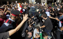 <p>Pro-independence demonstrators try to stop the car carrying Xavier Puig, a senior at the Department of External Affairs, Institutional Relations and Transparency of the Catalan Government office, after he was arrested by Guardia Civil officers in Barcelona, Spain, Wednesday, Sept. 20, 2017. (Photo: Emilio Morenatti/AP) </p>
