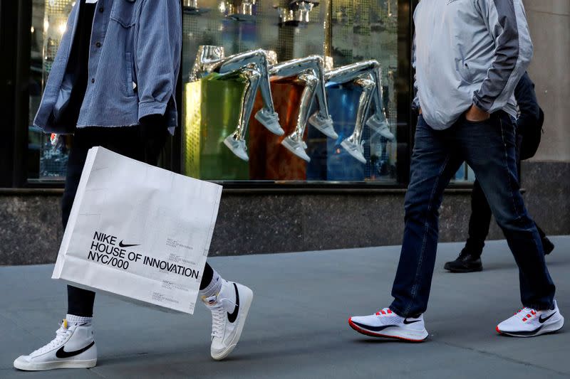 FILE PHOTO: People shop on 5th Avenue in New York