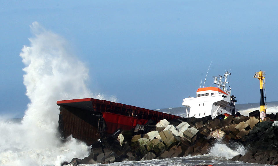 Waves knock against the wreck of the Spanish cargo ship "Luno" that slammed into a jetty in choppy Atlantic Ocean waters and broke in two, off Anglet, southwestern France, Wednesday, Feb. 5, 2014. The ship had been heading to a nearby port to load up with cargo when its engine failed and the rough waves carried it into the jetty. (AP Photo/Bob Edme)