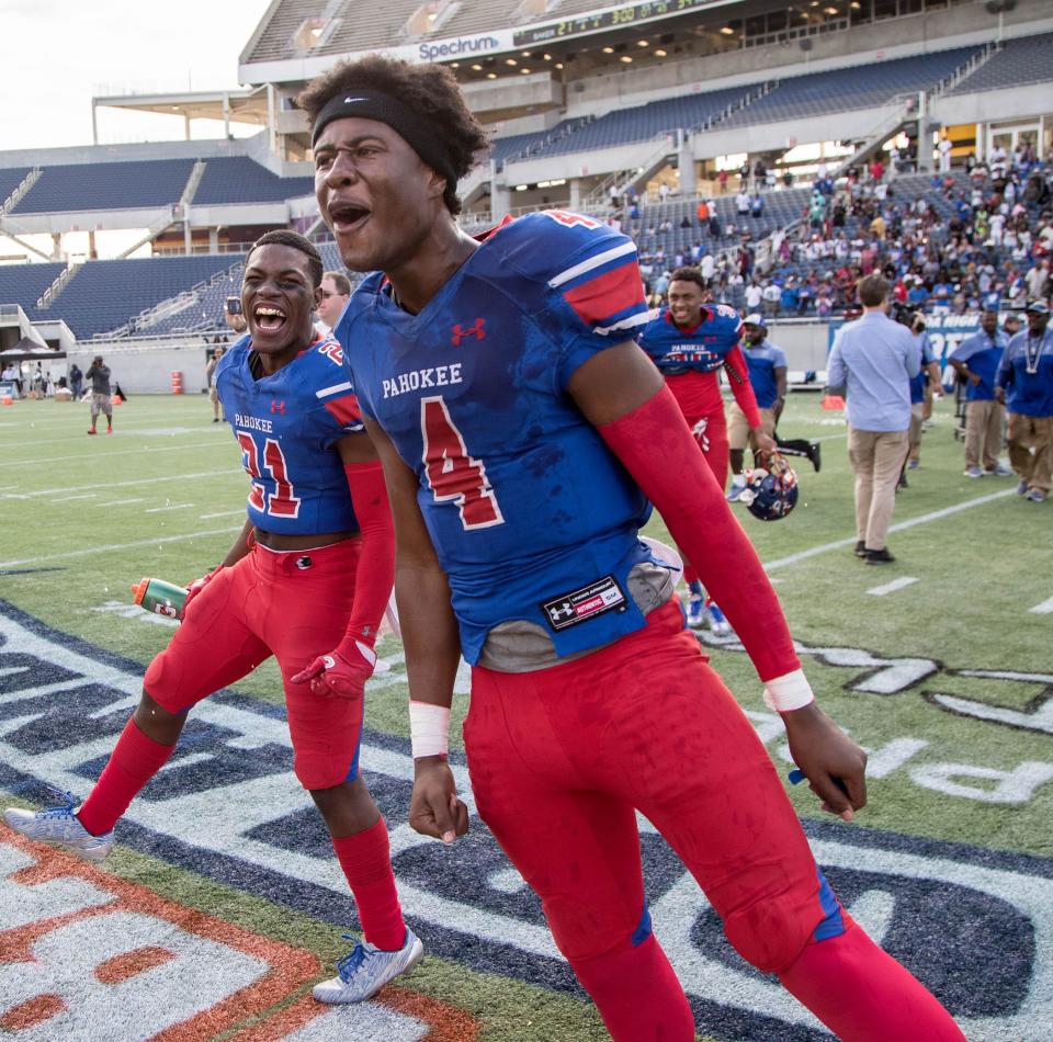 Pahokee's Tyrone Smith and Archie Johnson celebrate Blue Devils' victory win over Baker in the Class 1A state championship game. The title was later vacated.
