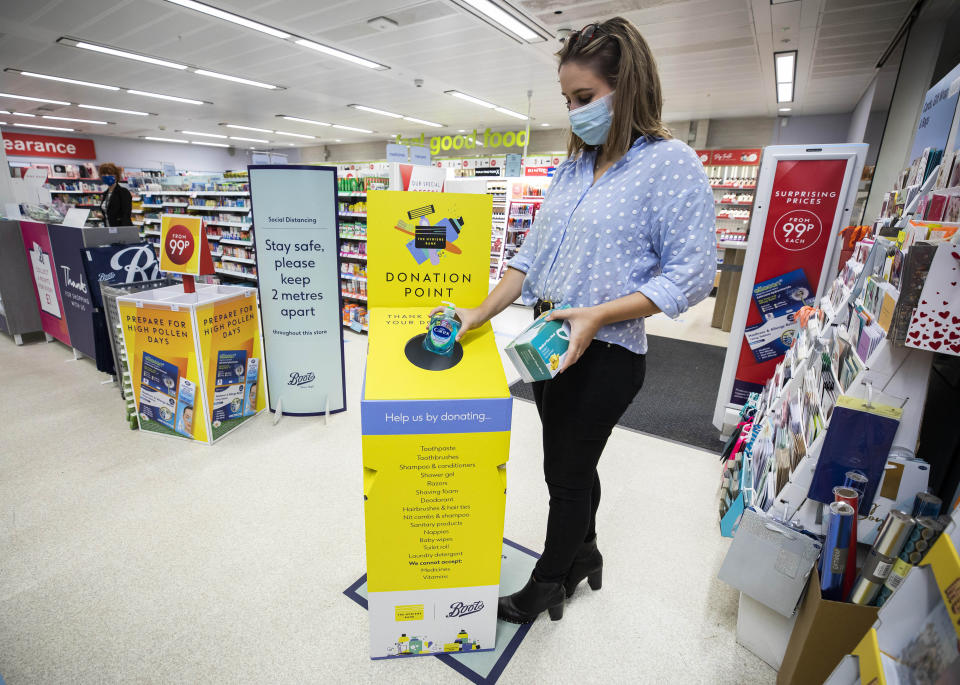 EDITORIAL USE ONLY?? A Boots customer donates a bottle of hand wash and masks to add to the 84,000 PPE products, including face masks and hand sanitiser??for The Hygiene Bank charity in Nottingham, as the??health and beauty retailer??makes the donation??to help tackle hygiene poverty in the UK.