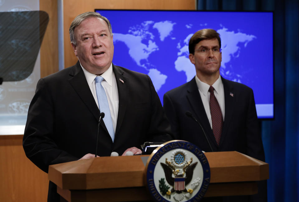 Secretary of State Mike Pompeo speaks as Defense Secretary Mark Esper listens, during a joint briefing, Thursday, June 11, 2020 at the State Department in Washington, on an executive order signed by President Donald Trump aimed at the International Criminal Court. Trump has lobbed a broadside attack against the International Criminal Court. He's authorizing economic sanctions and travel restrictions against court workers directly involved in investigating American troops and intelligence officials for possible war crimes in Afghanistan without U.S. consent. The executive order Trump signed on Thursday marks his administration’s latest attack against international organizations, treaties and agreements that do not hew to its policies. (Yuri Gripas/Pool via AP)