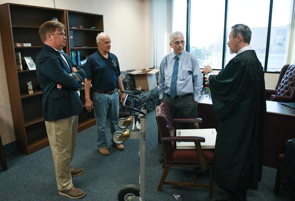 Circuit Judges (from left) Michael Linn, Robert Belanger, Steve Levin, and Michael Heisey socialize as Belanger packs up his belongings inside his chambers in the St. Lucie County Courthouse on Monday, Nov. 6, 2023, in downtown Fort Pierce. Judge Belanger is retiring after 18 years on the bench and 10 years as a high profile state prosecutor in Stuart.