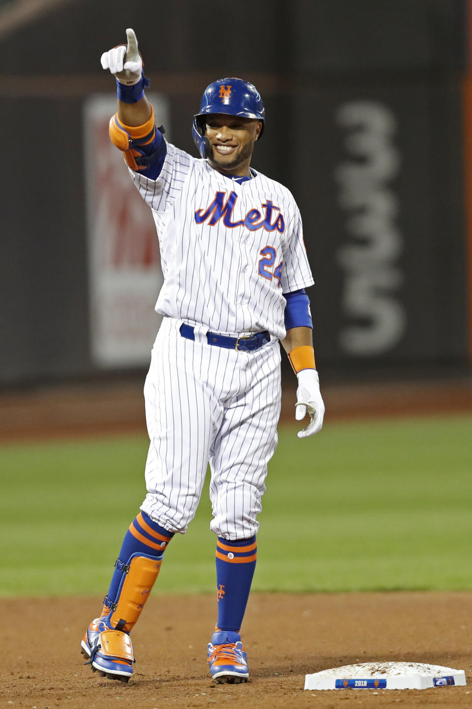 New York Mets' Robinson Cano gestures toward the Mets' dugout after hitting a double during the third inning of the team's baseball game against the Miami Marlins, Wednesday, Sept. 25, 2019, in New York. (AP Photo/Kathy Willens)