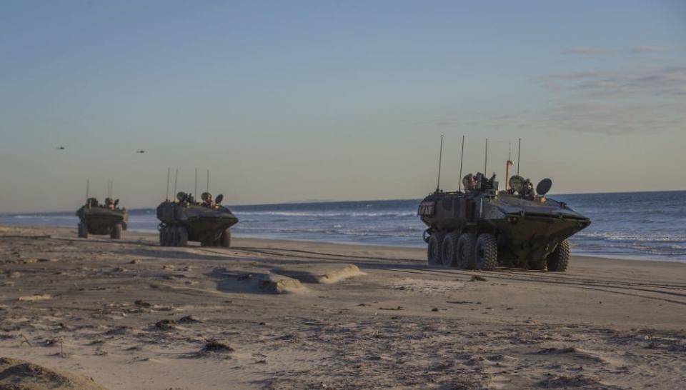 Marines with Amphibious Vehicle Test Branch, Marine Corps Tactical Systems Support Activity, drive new Amphibious Combat Vehicles along the beach