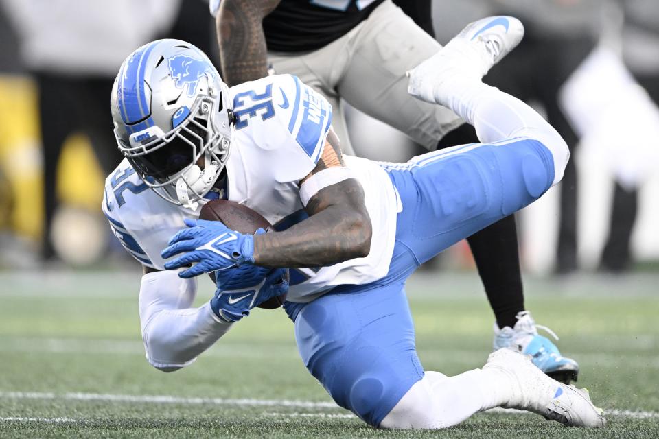 D'Andre Swift (32) of the Detroit Lions carries the ball against the Carolina Panthers during the third quarter of the game at Bank of America Stadium on December 24, 2022 in Charlotte, North Carolina.