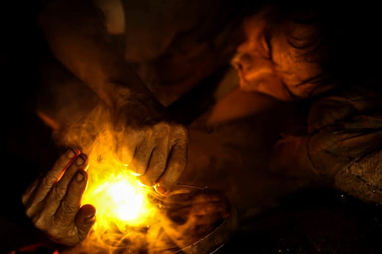 Hmong tribesman Vo Pali takes a hit from his opium pipe at his village northern Laos