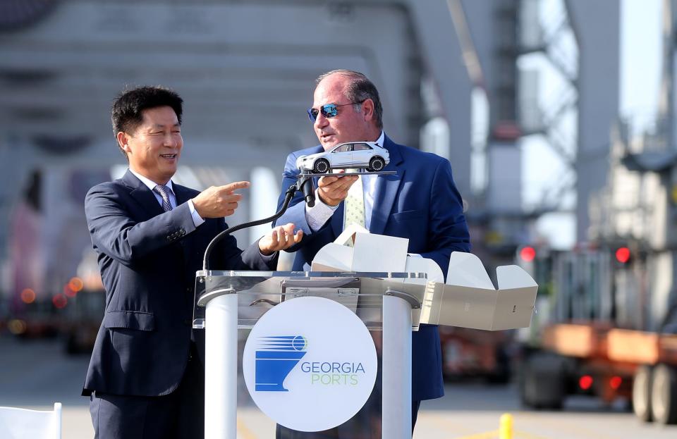 Oscar Kwon, HMGMA president and CEO, presents Kent Fountain, chairman of the Georgia Ports Authority Executive Board, with a model of an electric car during a ceremony to mark the arrival of the first shipment of equipment for the Hyundai Metaplant.