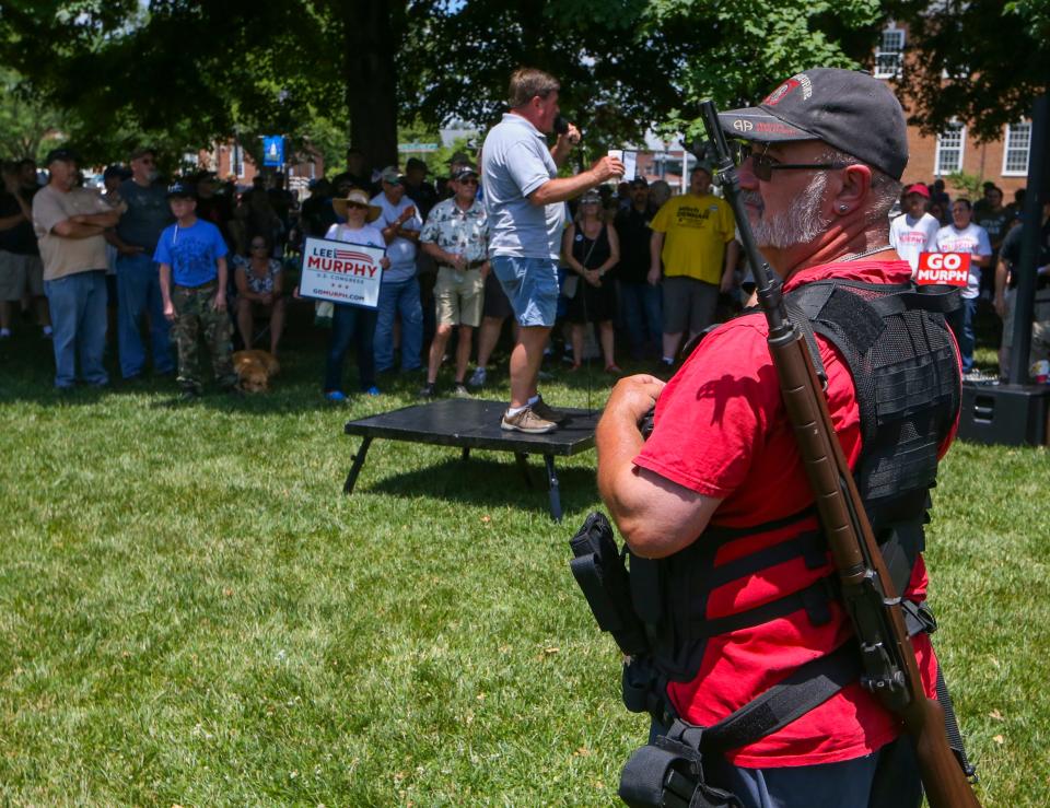 Jeff Hague of the Delaware State Sportsmen's Association speaks to the crowd as Robert Ashby of New Castle stands with a rifle during a pro-gun rights rally on the Legislative Mall in Dover, Saturday, June 25, 2022.