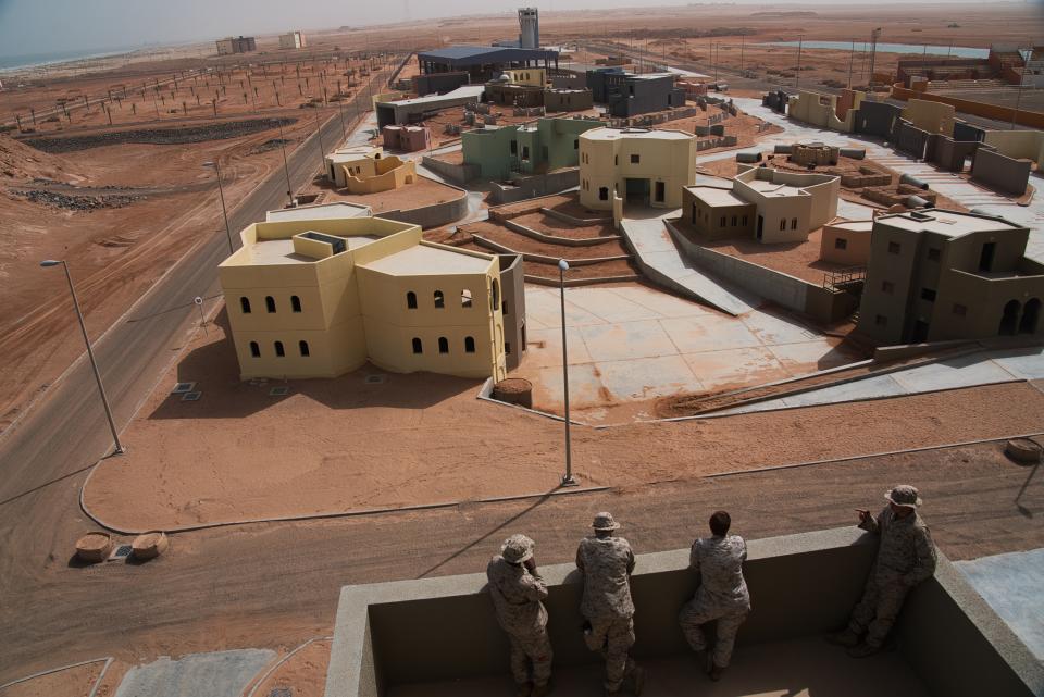 U.S. Marines overlook a Military Operations in Urban Terrain facility during an exercise at an Emirati military base in al-Hamra, United Arab Emirates, Monday, March 23, 2020. The U.S. military held the major exercise Monday with Emirati troops in the UAE's far western desert at a facility designed to look like a Mideast city amid ongoing tensions with Iran. (AP Photo/Jon Gambrell)