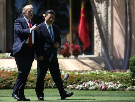 U.S. President Donald Trump (L) and China's President Xi Jinping take a walk together after a bilateral meeting at Trump's Mar-a-Lago estate in Palm Beach, Florida, U.S., April 7, 2017. REUTERS/Carlos Barria