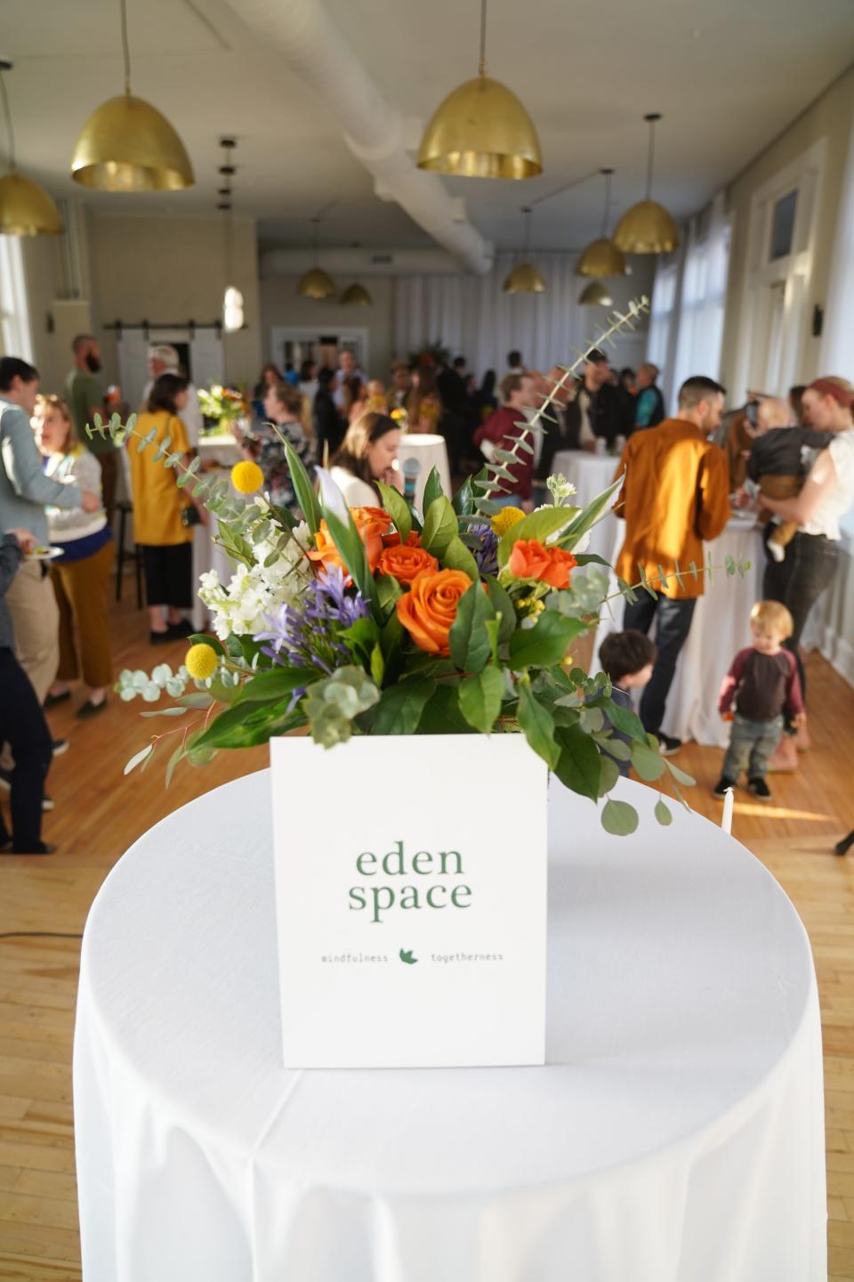 People celebrate during the launch party for Eden Space, an "online mindfulness garden" for those going through pregnancy and postpartum depression, on April 28 at Convolo in Sioux Falls.