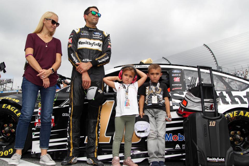 Oct 7, 2018; Dover, DE, USA; NASCAR Cup Series driver Aric Almirola stands with his wife Janice and children Abby and Alex prior to the Gander Outdoors 400 at Dover International Speedway. Mandatory Credit: Matthew O'Haren-USA TODAY Sports