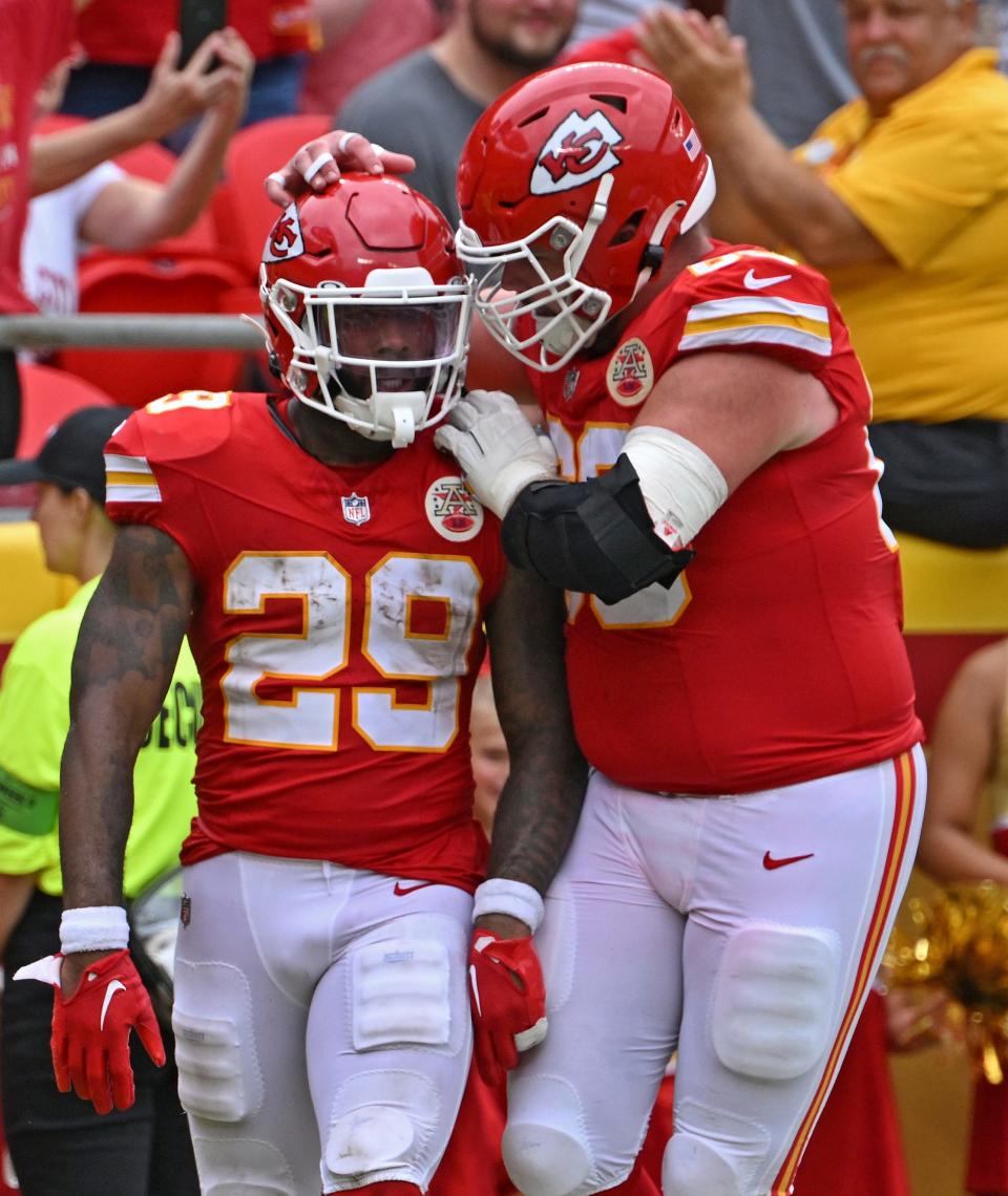 Kansas City lineman Mike Caliendo (right) congratulates running back La'Mical Perine after a touchdown Aug. 26, 2023.