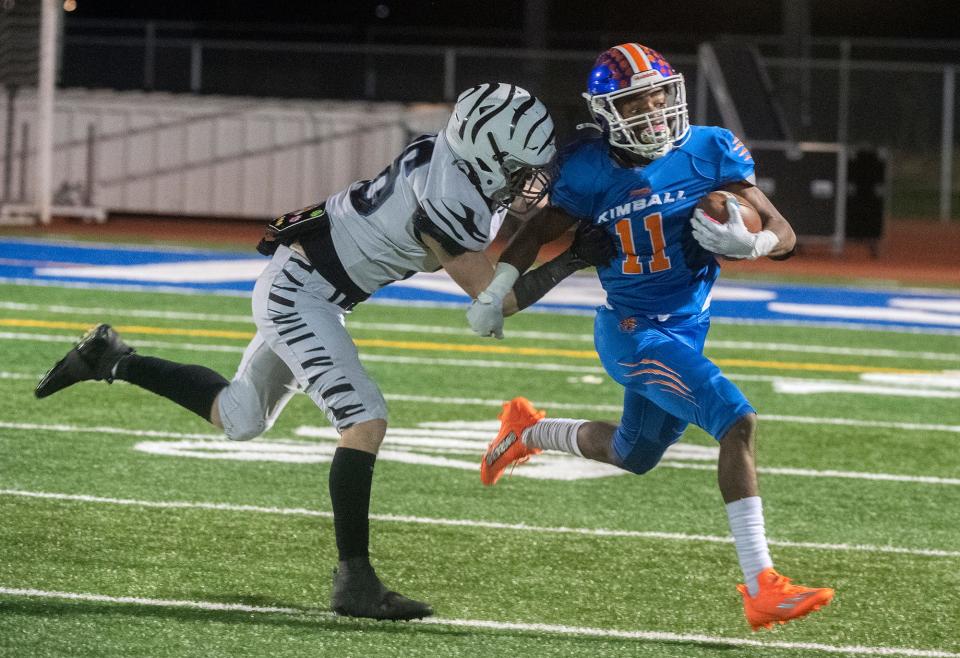 Kimball Jaguars' Darius Doyle, right, tries to get away from Lincoln Fighting Zebras' Kyle Klein during a Sac-Joaquin Section Division IV football playoff game at Kimball in Tracy on Friday, Nov. 11, 2022. 