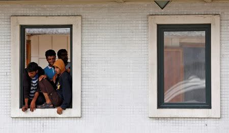 Syrian migrants look out from a window of a mosque in Istanbul, Turkey, September 15, 2015. REUTERS/Murad Sezer