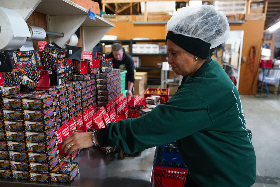 Angie Maldonado helps box tinned fish products for Los Angeles-based company Fishwife, Friday, Oct. 13, 2023, at a cannery in Bay Center, Wash. (AP Photo/Lindsey Wasson)