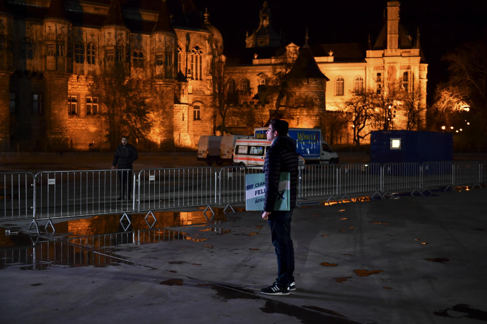 A lone supporter of opposition leader Peter Marki-Zay waits for preliminary results of the general election on a cold night in Budapest, Hungary, Sunday, April 3, 2022. Hungarians voters in the Central European country faced a choice: take a chance on a diverse, Western-looking coalition of opposition parties, or grant nationalist Prime Minister Viktor Orban a fourth consecutive term. (AP Photo/Anna Szilagyi)