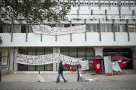 A man walks past an empty sit-in due to a national lockdown in Tunis' landmark Avenue Habib Bourgiba, where massive protests took place in 2011, on the tenth anniversary of the uprising , in Tunis, Thursday, Jan. 14, 2021. Tunisia is commemorating the 10th anniversary since the flight into exile of its iron-fisted leader, Zine El Abidine Ben Ali, pushed from power in a popular revolt that foreshadowed the so-called Arab Spring. But there will be no festive celebrations Thursday marking the revolution in this North African nation, ordered into lockdown to contain the coronavirus. (AP Photo/Mosa'ab Elshamy)