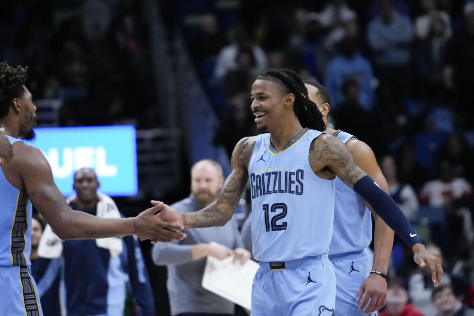 Memphis Grizzlies guard Ja Morant (12) reacts after his slam dunk in the final seconds of overtime during an NBA basketball game in New Orleans, Tuesday, Dec. 26, 2023. The Grizzlies won 116-115. (AP Photo/Gerald Herbert)